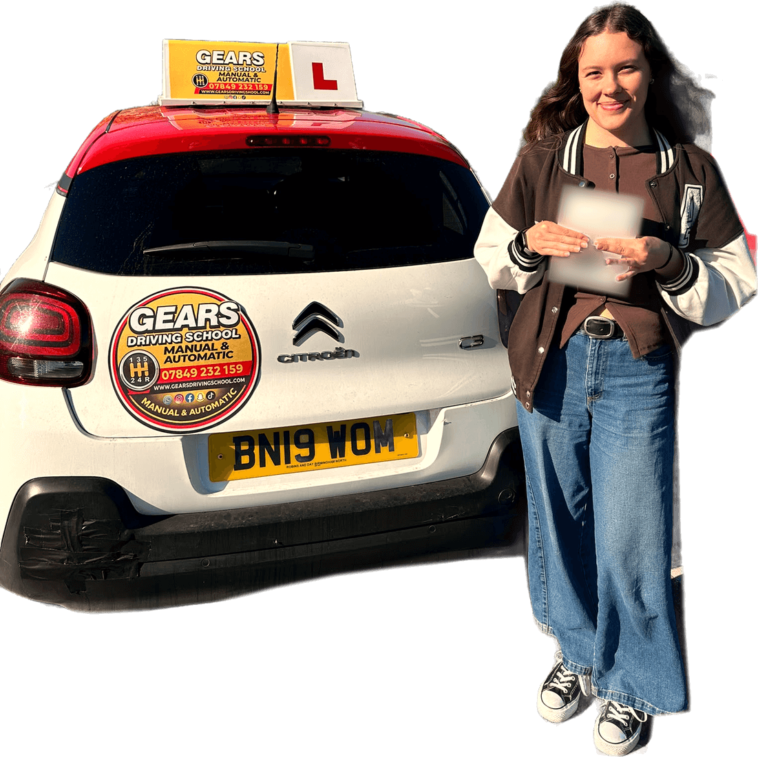 A smiling learner holds a pass certificate beside a white Gears Driving School car with its roof sign and L plate